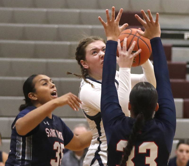 Cary-Grove's Ellie Mjaanes goes up for a shot against St. Viator's Mia Bergstrom during an IHSA Class 3A Antioch Sectional semifinal girls basketball game on Tuesday, Feb. 20, 2024, at Antioch High School.