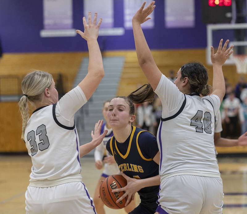 Sterling’s Madison Austin works against Dixon’s Jessie Pitman and Hallie Williamson Tuesday, Feb. 13, 2024 during a regional semifinal at Rochelle.