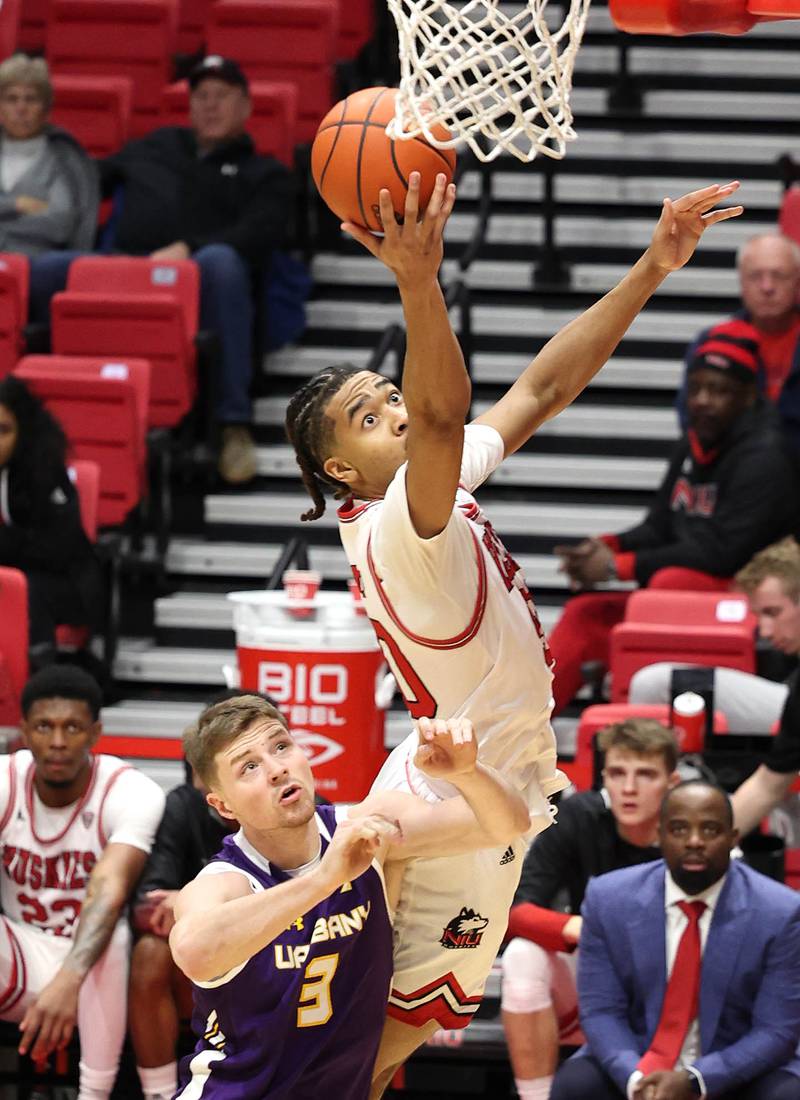 Northern Illinois Huskies guard Anthony Crump is fouled by Albany Great Danes forward Trey Hutcheson during their game Tuesday, Dec. 20, 2022, in the Convocation Center at NIU in DeKalb.