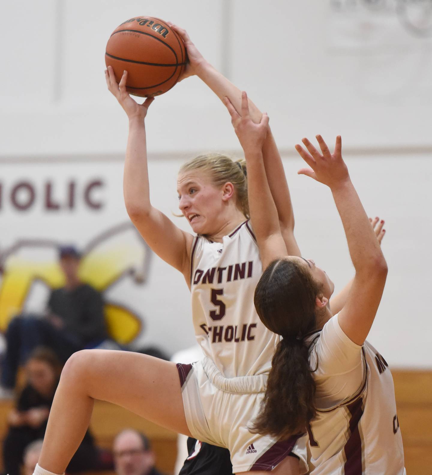 Montini’s Victoria Matulevicius grabs a rebound next to teammate Alyssa Epps during the semifinal of the Montini girls basketball tournament, played against Benet Academy, on Thursday December 28, 2023 in Lombard.