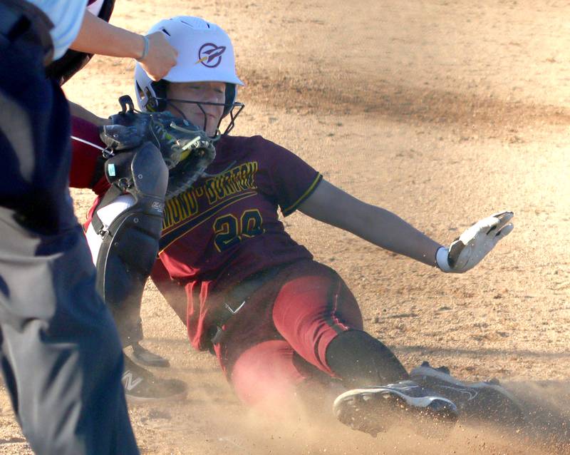 Richmond-Burton’s Lilly Kwapniewski is tagged out at home in varsity softball at Marengo Monday.