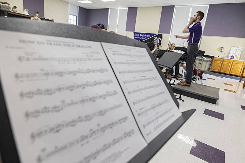 Dixon High School band director Riley Carter conducts his band Tuesday, April 11, 2023. Carter and company are practicing for the upcoming music contests.