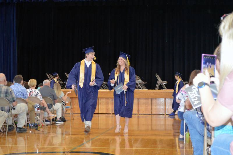 Polo Community High School graduates Brock Soltow, left, and Aylivia Danekas walk down the aisle at the end of the Class of 2024's commencement ceremony on Sunday, May 19, 2024.