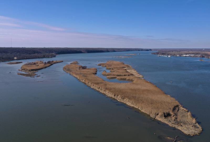 An aerial view of Delbridge Island looking west toward the Starved Rock Lock and Dam on Tuesday, Feb. 13, 2024 near Starved Rock State Park. The Starved Rock Breakwater project is a habitat restoration effort designed to restore submerged aquatic vegetation in the Illinois River, Starved Rock Pool. It will increase the amount and quality of resting and feeding habitat for migratory waterfowl and improve spawning and nursery habitat for native fish.
Construction of the breakwater will involve placement of riprap along northern edge of the former Delbridge Island, adjacent to the navigation channel between River Mile 233 and 234. The breakwater structure will be approximately 6,100 feet long and constructed to a design elevation 461.85 feet, providing adequate protection to allow for submerged aquatic vegetation growth.
The estimated total cost of this project is between $5 and $10 million.