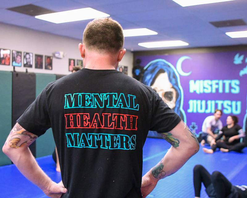 Brad Edmondson the owner and operator of The Misfits Jiujitsu of St. Charles wears one of his Misfits T-shirts that reads “Mental Health Matters” on Wednesday March 3, 2024.