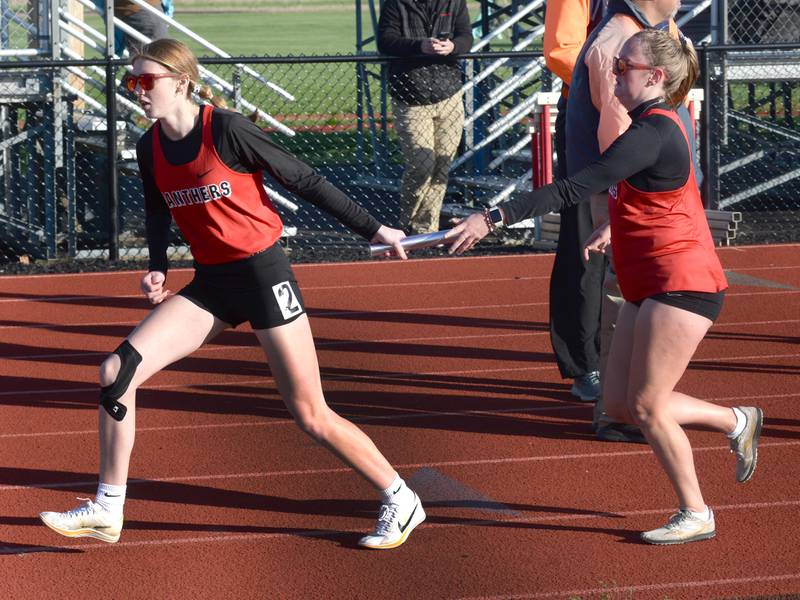 Erie-Prophetstown's Brooke Lalley hands the baton to Sarah Link in the 4x800 at the Ed Schmidt Invitational Track Meet at Erie High School on Friday, April 19, 2024.