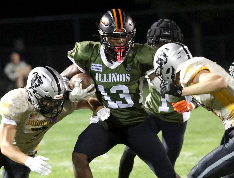 DeKalb's Davon Grant tries to get between two Kaneland defenders during their game Friday, Sept. 13, 2024, at Kaneland High School in Maple Park.