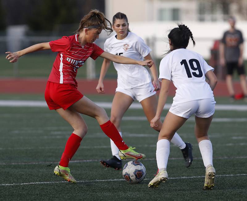 Huntley’s Ava Trudeau controls the ball between McHenry's Maya Gil (center) and Jasmine Ortiz during a Fox Valley Conference soccer match Thursday, April 13, 2023, at Huntley High School.