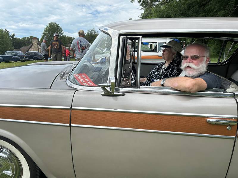 Charlie and Maggie Wilson eat their lunches while sitting in their 1957 Rambler Rebel at the Nashional Car Show at the Stronghold Camp & Retreat Center north of Oregon on Saturday, June 29, 2024. The Wilsons drove their Rambler to Illinois from their home in Canton, Ohio.