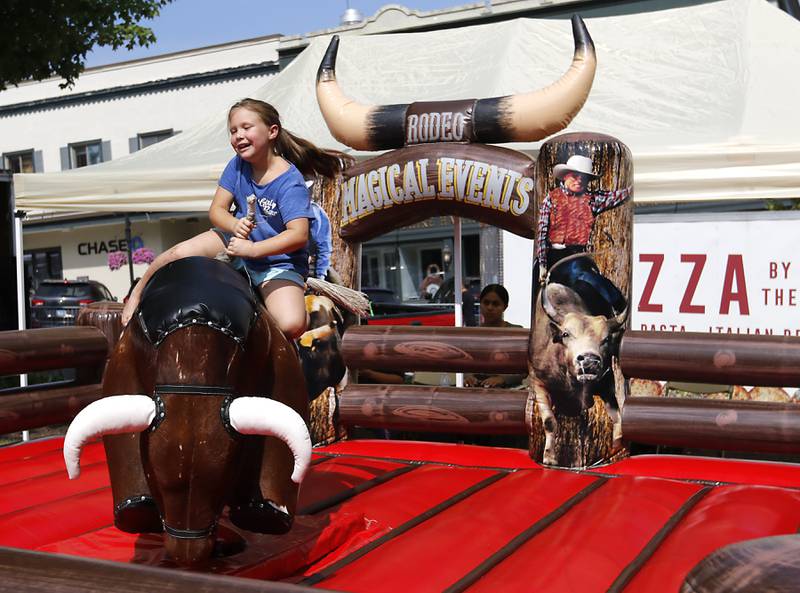 Gabby Kakareko of Woodstock rides on a mechanical bull during the annual Hispanic Connections Mexican Independence Day Celebration on Sunday, Sept. 15, 2024, in the Historic Woodstock Square. The celebration featured music, food and culture.