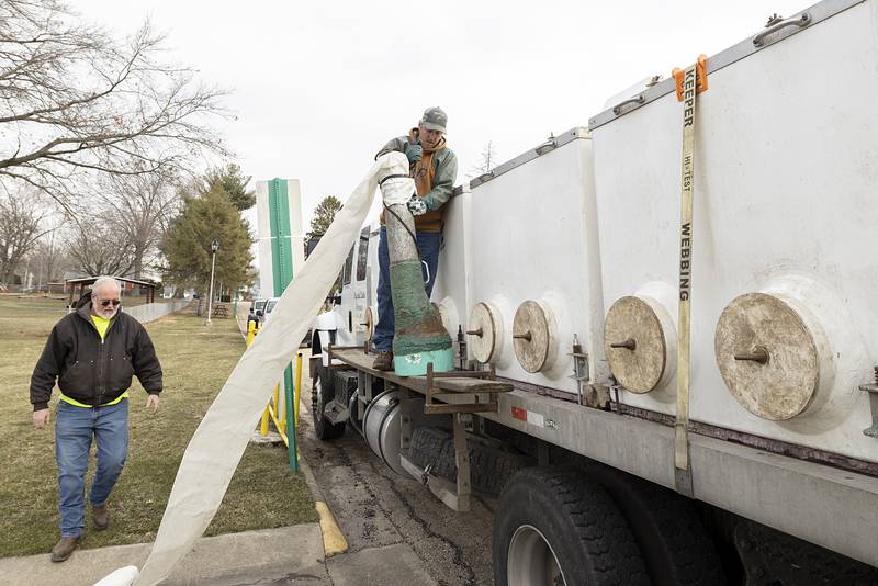 Cody Herrell, right, driver for Crystal Lake Fisheries of Missouri, starts to stock Rock Falls' Centennial Park pond Tuesday, March 21, 2023, with more than 1,900 pounds of trout for the upcoming fishing season. Trout season will start on April 1.