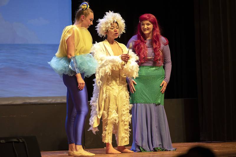 Flounder, Scuttle and Ariel played by Reese Dykstra, Mikaela Migraso and Paige Lower act out a scene Friday, April 26, 2024 during opening night of Fulton High School’s “The Little Mermaid.”