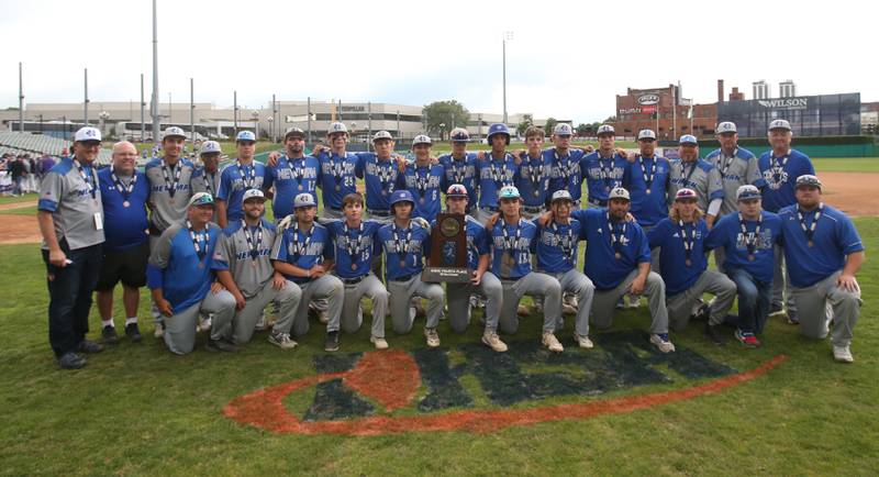 Members of the Newman baseball team pose with their Class 2A fourth place trophy on Saturday, June 1, 2024 at Dozer Park in Peoria.