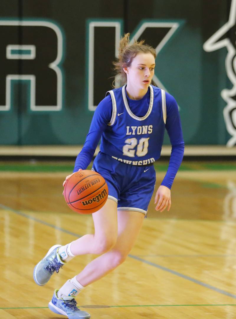 Lyons' Ella Ormsby (20) brings the ball up court during the girls varsity basketball game between Lyons Township and York high schools on Friday, Dec. 16, 2022 in Elmhurst, IL.