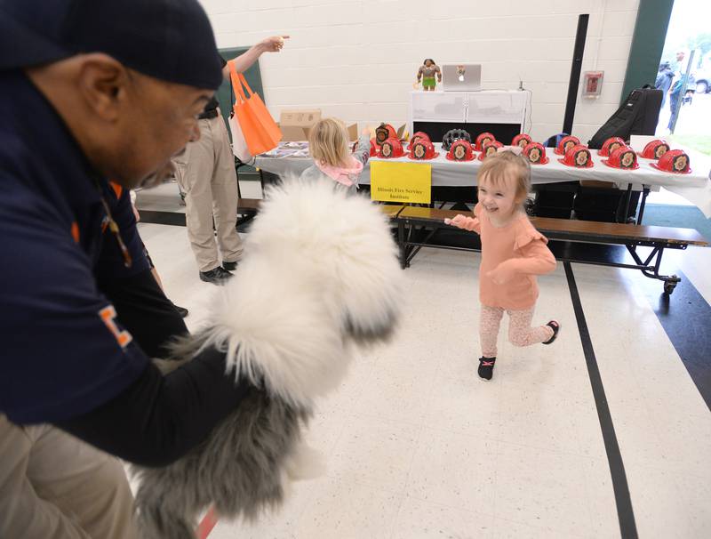 Sarah Lacewell of Plainfield dances to "What did the Fox Say" while Illinois Fire Institute staff member Doc Patterson entertains and educates children during the Child Safety Expo held at Lakeview Junior High in Downers Grove Saturday June 1, 2024.