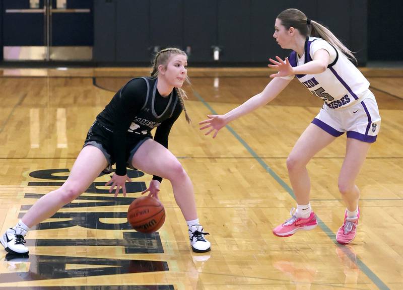 Kaneland's Kendra Brown dribbles in front of Dixon’s Morgan Hargrave Thursday, Feb. 22, 2024, during their Class 3A sectional final game at Sycamore High School.