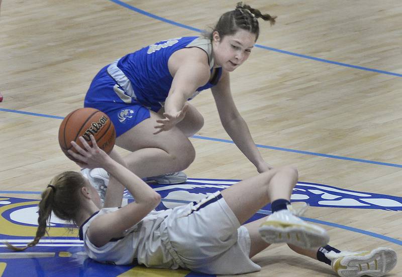 Marquette’s Keely Nelson works to get a pass off from a loose ball past Princeton’s Miyah Fox during the 1st period in Bader Gymnasium on Saturday, Jan. 7, 2023 at Marquette High School.