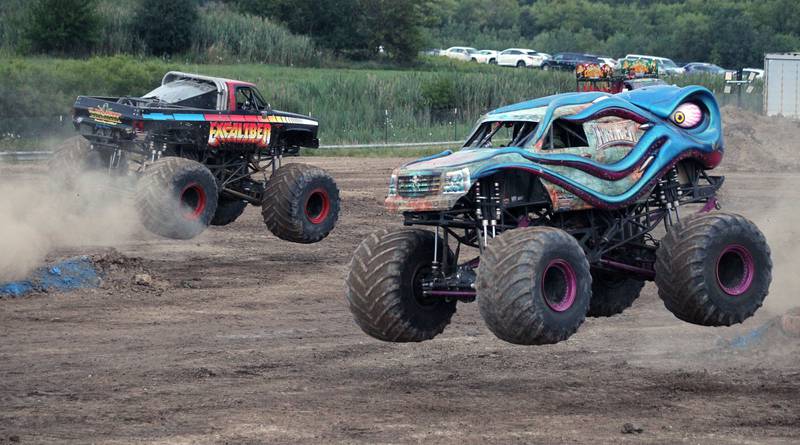 Brothers Mikey and Nick Pagliarulo compete in their monster trucks, Excaliber and Kraken, during the championship race in the Monster Truck Throwdown during the Lake County Fair at the Lake County Fairgrounds on Friday, July 28, 2023, in Grayslake.