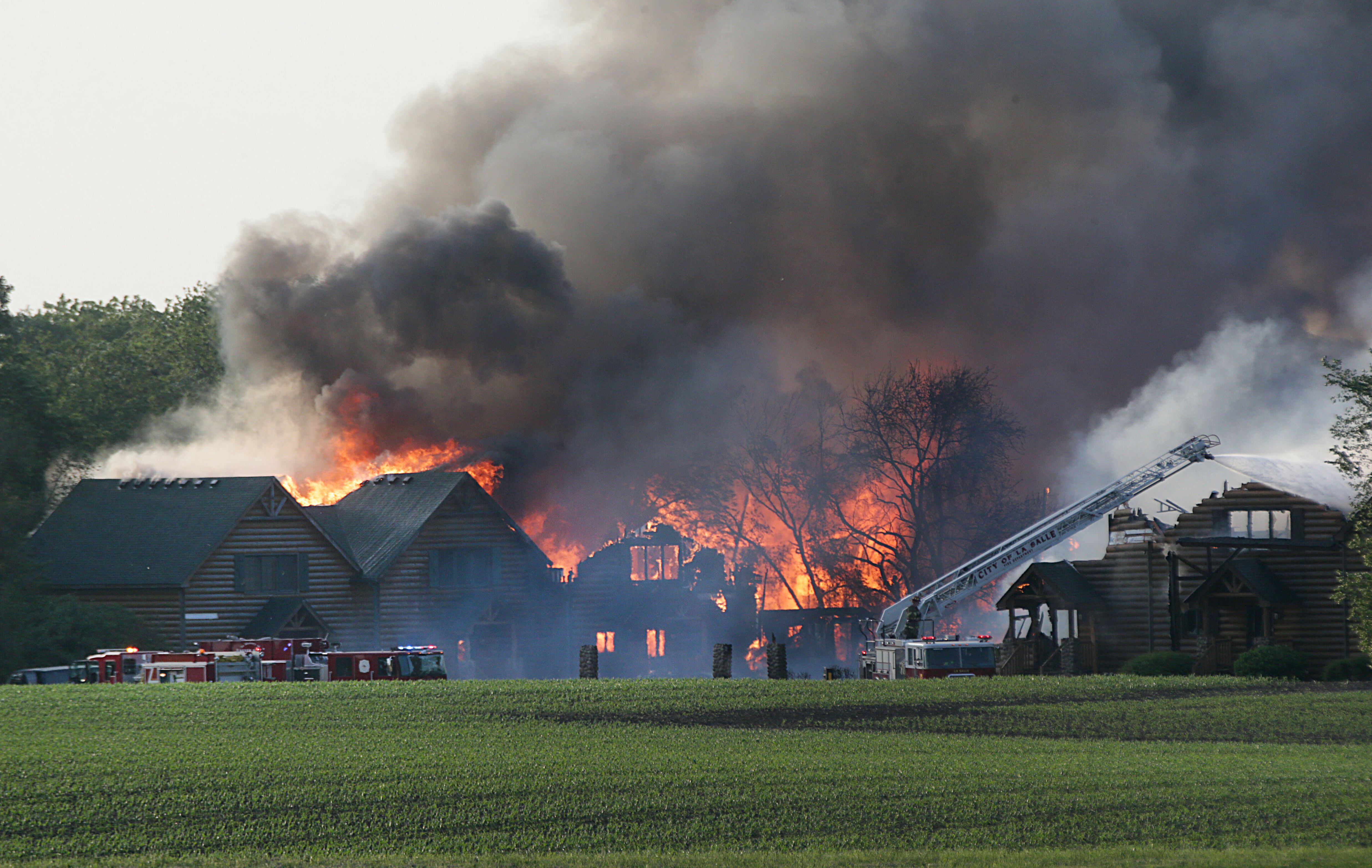 Large flames engulf several cabins at Grand Bear Resort on Monday, May 30, 2022. High winds made it difficult for firefighters to battle the flames.