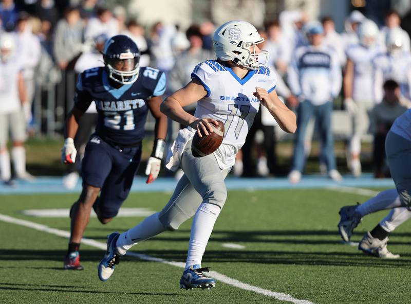 St. Francis' Alessio Milivojevic (11) looks for a receiver during the boys varsity IHSA 5A semifinal between Nazareth Academy and St. Francis high school in La Grange Park, IL on Saturday, Nov. 18, 2023.