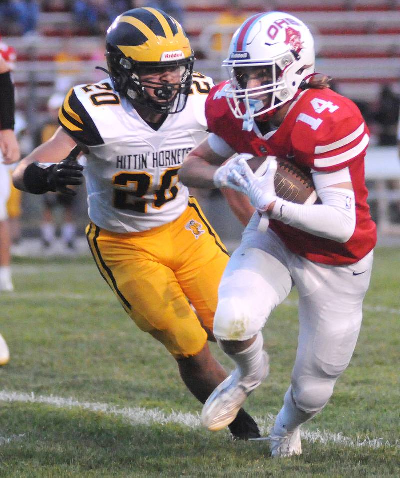 Harvard's Angel Deleon (20) slows down Ottawa's Archer Cechowicz at King Field on Friday, Sept. 8, 2023.