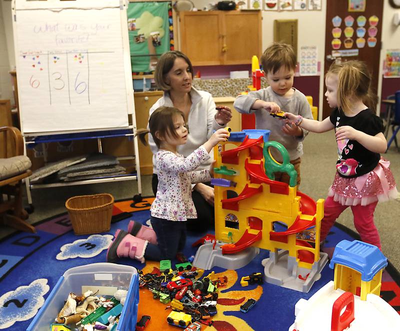 Teacher Lisa Kobrluch watches as Genevieve, Teddy, and Faye play with cars on Tuesday Jan. 23, 2024, at the Purple Moose in Crystal Lake. The preschool will close down after the current school year finishes in June, unless the school can find another location after the Shiloh Church decided not to renew the preschool's lease.