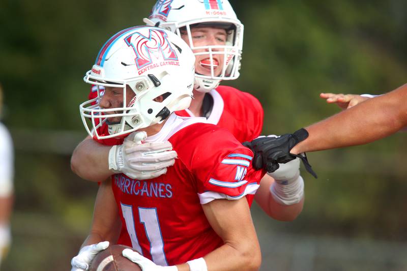 Marian Central’s Maxwell Kinney, front, is greeted by Eddie Gilmore after a Kinney touchdown. Against Bishop McNamara in varsity football action on Saturday, Sept. 14, 2024, at George Harding Field on the campus of Marian Central High School in Woodstock.