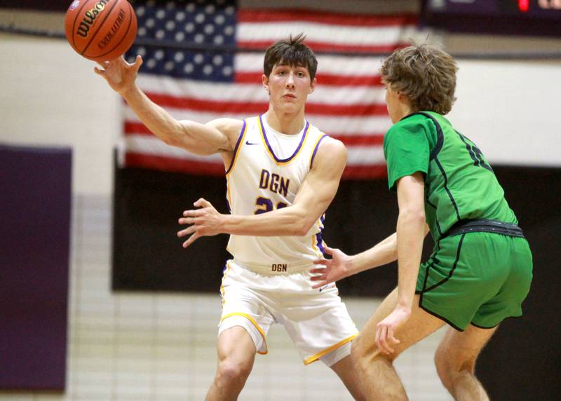 Downers Grove North’s Jack Stanton (left) passes the ball during a game against York at Downers Grove North on Friday, Jan. 19, 2024.