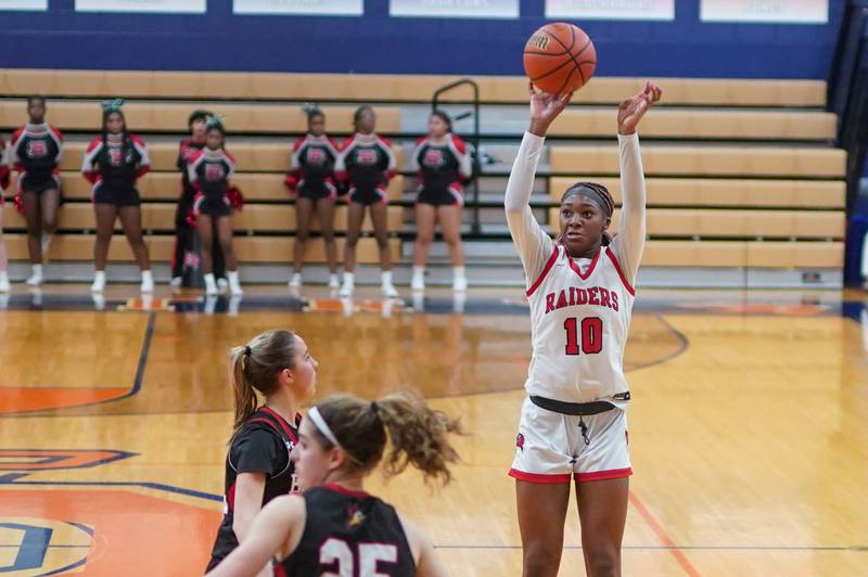 Bolingbrook's Trinity Jones (10) shoots a three pointer against Benet during a Oswego semifinal sectional 4A basketball game at Oswego High School on Tuesday, Feb 20, 2024.