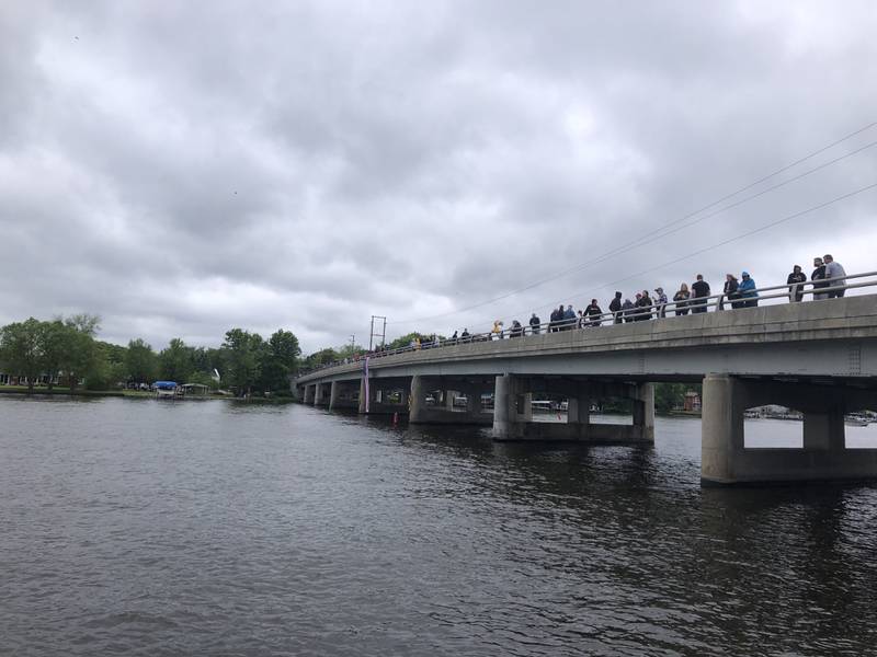 Attendees line the Fox River bridge during the Johnsburg Memorial Day ceremony Monday May 27, 2024.