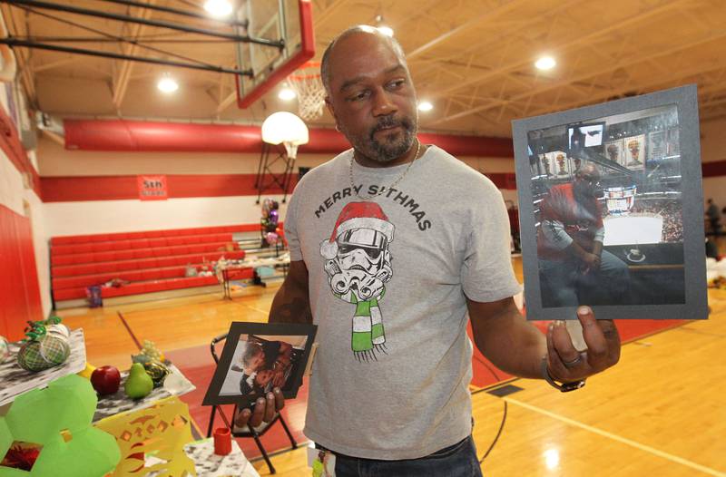 Lemar Wilson, of Grayslake shows a photo of a loved one a student wanted displayed on an altar made by Stanton students during the Dia de los Muertos, Day of the Dead event at Stanton Middle School on November 3rd in Fox Lake. The event was sponsored by the Bilingual Parents Advisory Committee (BPAC) from School Districts 114,124 and 37.Wilson is an art teacher at Stanton and was putting up the altar for the students.
Photo by Candace H. Johnson for Shaw Local News Network