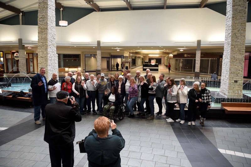 Former employees gather together for a photo on the last day of business at Spring Hill Mall on Friday, March 22, 2024.