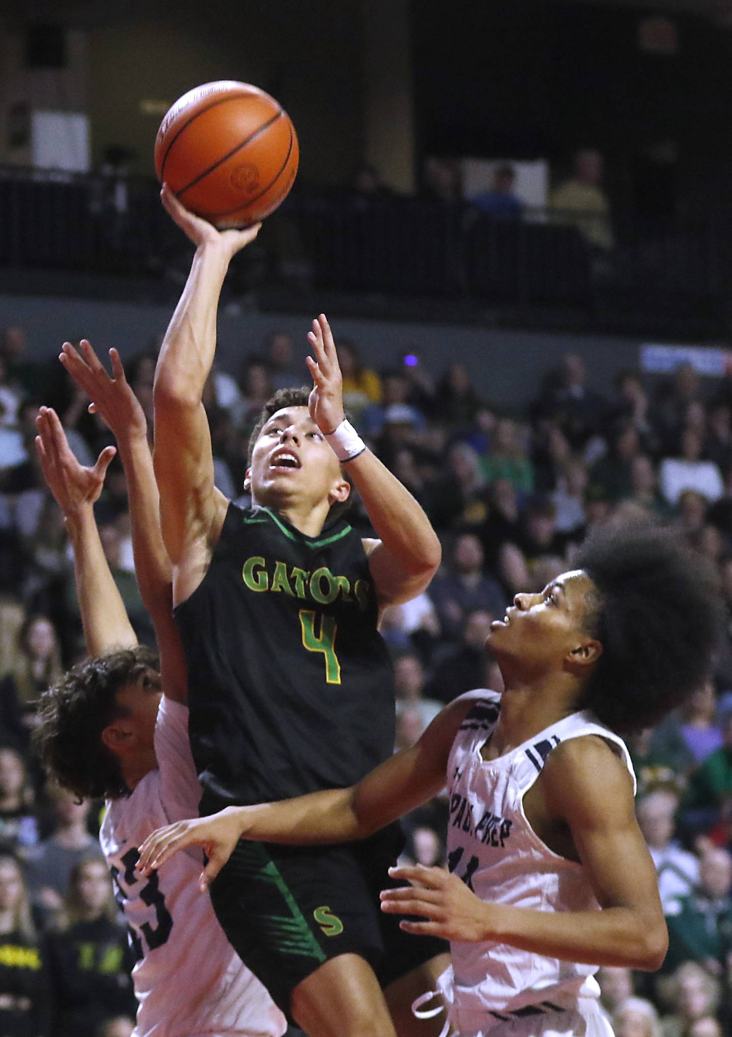 Crystal Lake South's AJ Demirov shoots the ball between DePaul College Prep's Jaylan Mcelroy (left) and Robert Walls (right) during the IHSA Class 3A Supersectional basketball game on Monday, March 4, 2024, at NOW Arena in Hoffman Estates.