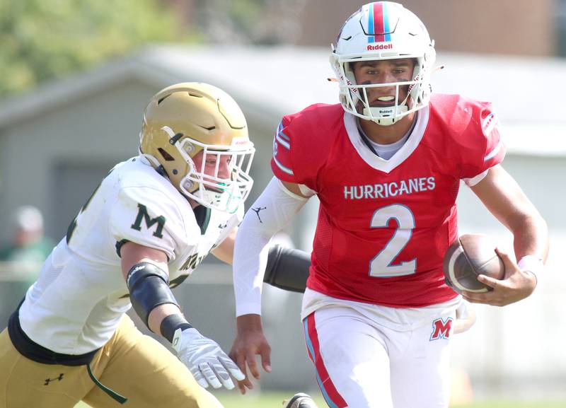 Marian Central’s Picasso Ruiz scrambles with the ball against Bishop McNamara in varsity football action on Saturday, Sept. 14, 2024, at George Harding Field on the campus of Marian Central High School in Woodstock.