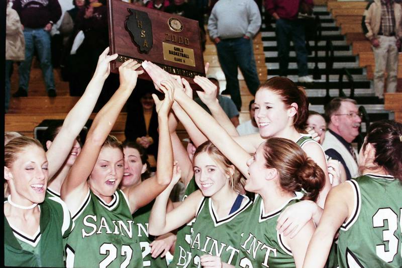 Members of the 1999-2000 St. Bede Lady Bruins hoist the Class 1A Sectional plaque after defeating Rockridge on Feb. 14, 2000 at Bureau Valley High School.