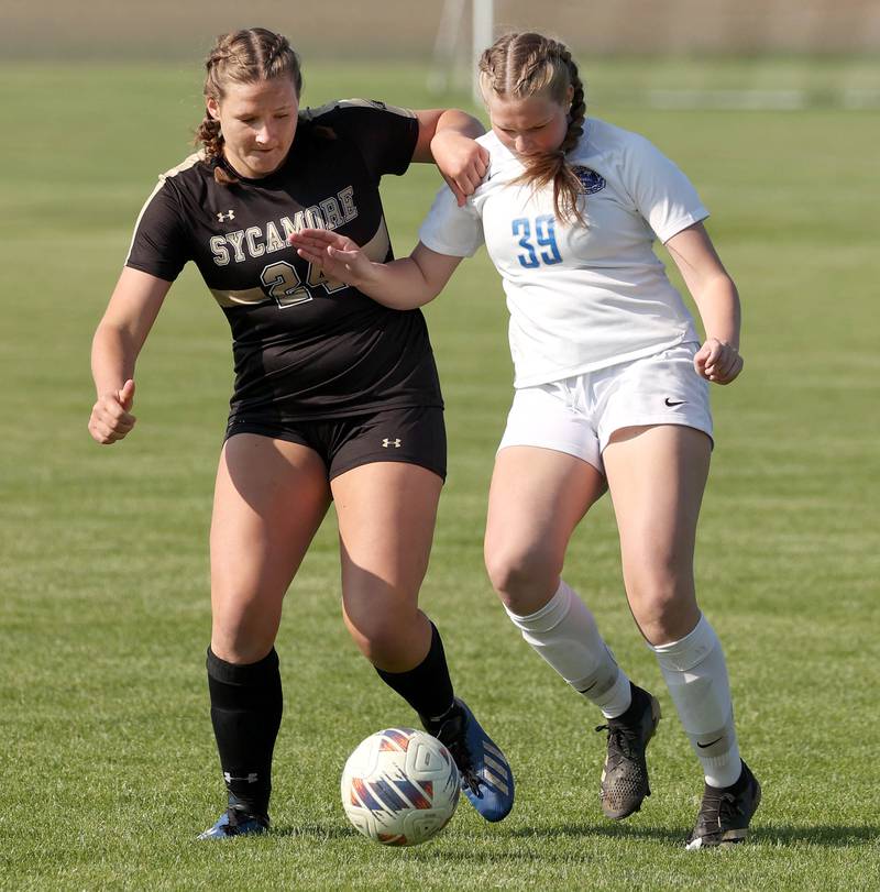 Sycamore's Avery Gerdes and Woodstock's Veronica Baker fight for possession during their Class 2A regional semifinal game Wednesday, May 15, 2024, at Kaneland High School in Maple Park.