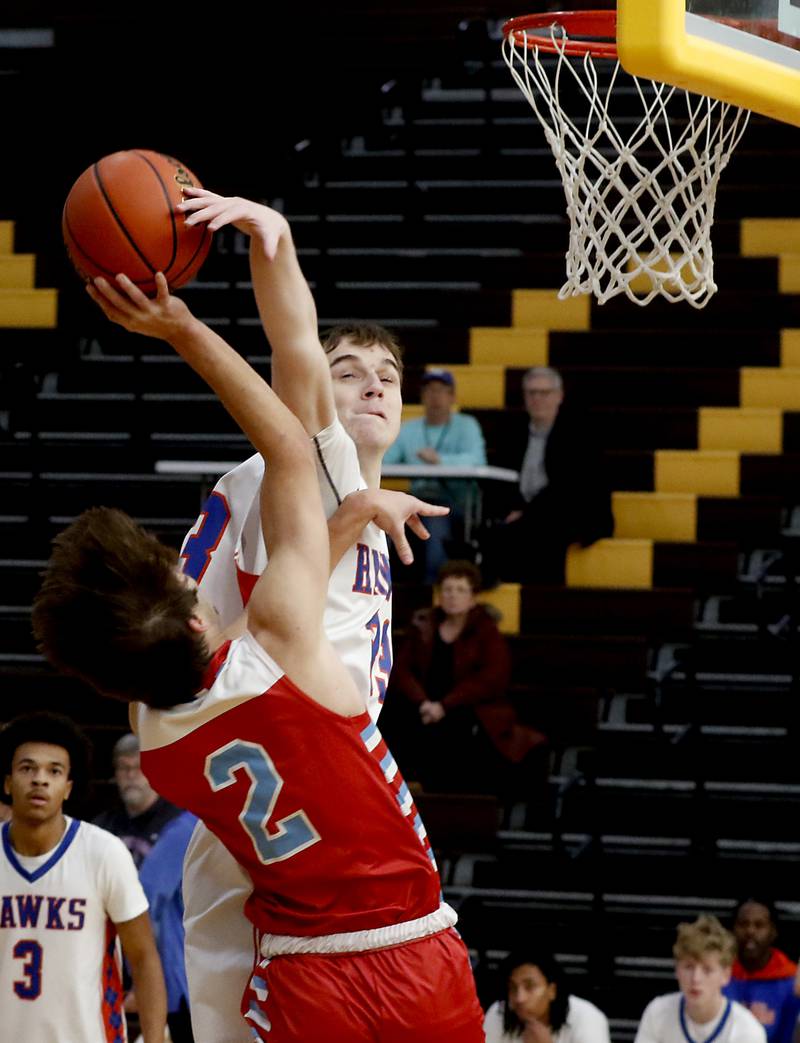 Marian Central's Jake Giangrego has his shot blocked by Hoffman Estates’ Adell Bosnjak during a Hinkle Holiday Classic basketball game Tuesday, Dec. 27, 2022, at Jacobs High School in Algonquin.