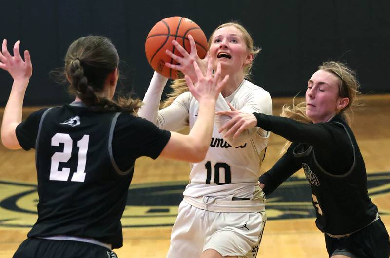 Sycamore's Lexi Carlsen goes between Kaneland's Kyra Lilly (left) and Alexis Schueler during their Class 3A sectional semifinal Tuesday, Feb. 20, 2024, at Sycamore High School.