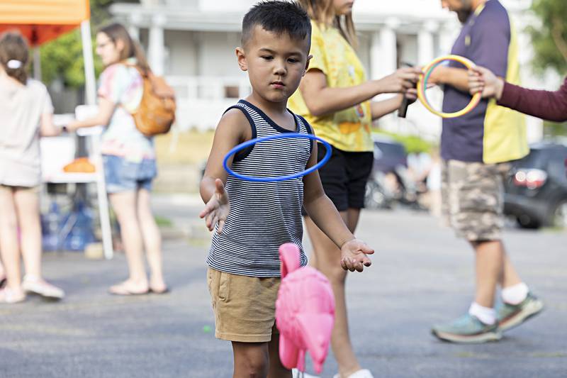 Henry Rock, 4, throws a ring Friday, June 30, 2023 during Family Fun Night in Dixon. The annual Family Fun Night near the old Lee County Courthouse kicked off Petunia Fest with an ice cream social, games for the kids, a touch-a-truck and music by the Dixon Municipal Band.