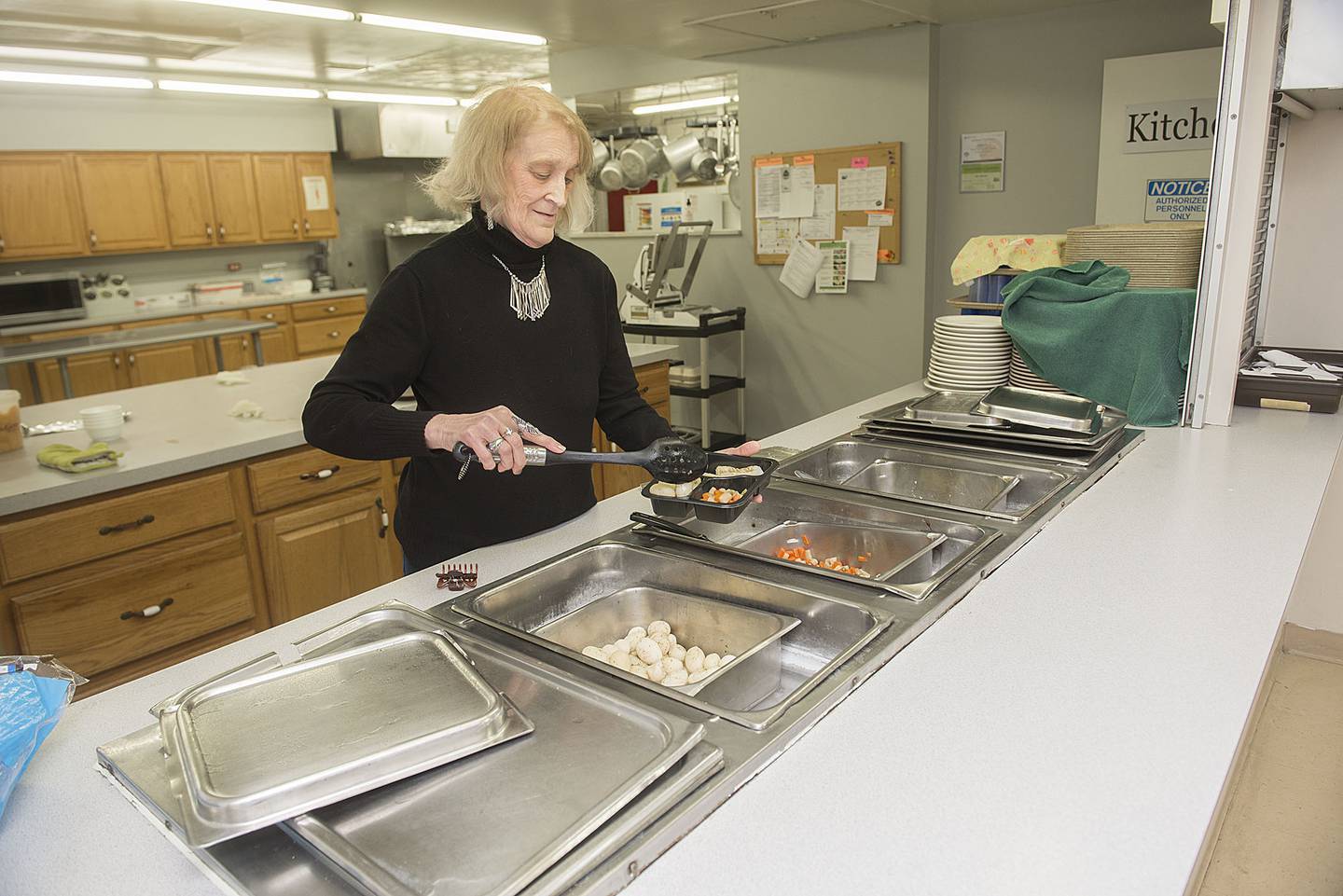 Linda Pennell dishes up food through the Golden Meals program at the senior center. Food is served Monday to Thursday from 11 a.m. to Noon for a small fee.
