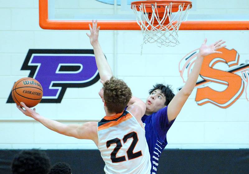 Plano defender Isaiah Martinez gets a little of Sandwich's "Dom Rome's elbow during a varsity basketball game at Sandwich High School on Tuesday, Feb. 13, 2024.