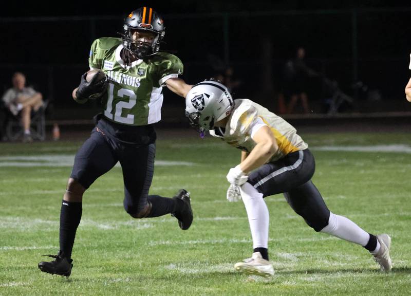 DeKalb's Derrion  Straughter goes around Kaneland's Luke Gadomski during their game Friday, Sept. 13, 2024, at Kaneland High School in Maple Park.