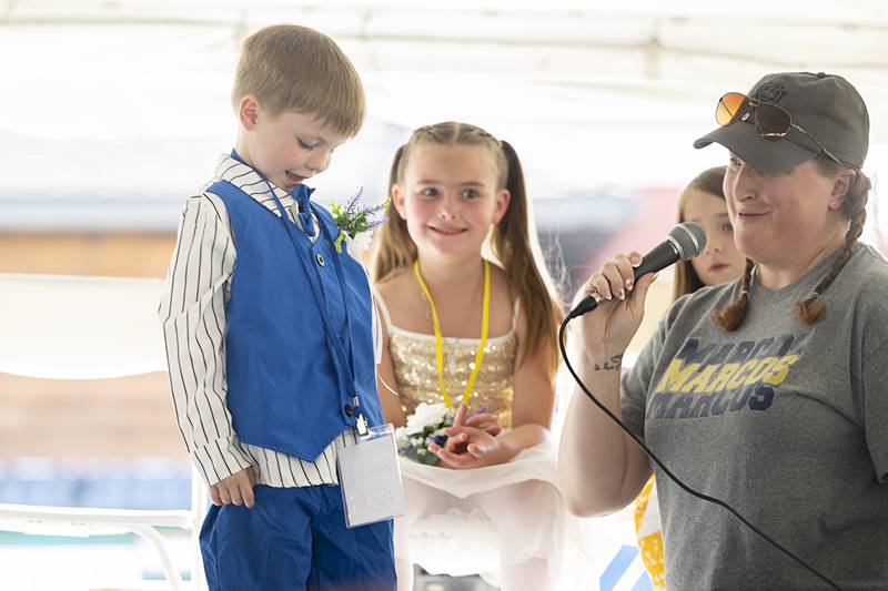 Jodi Merrell interviews the spiffily dressed Ricky Rippy Jr., 5, Thursday, June 13, 2024 for the Little Mister title at Polo’s Town and Country Days.