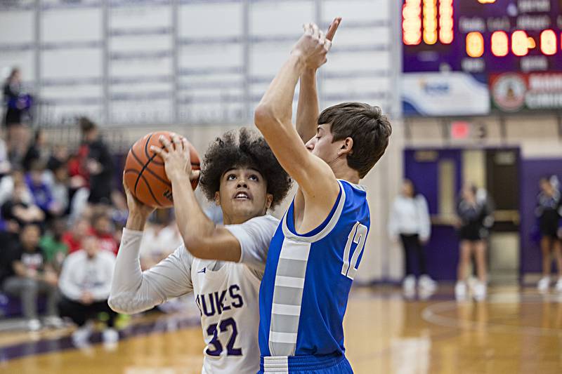 Dixon’s Darius Harrington works against Princeton’s Tyson PhillipsThursday, Dec. 21, 2023 at Dixon High School.