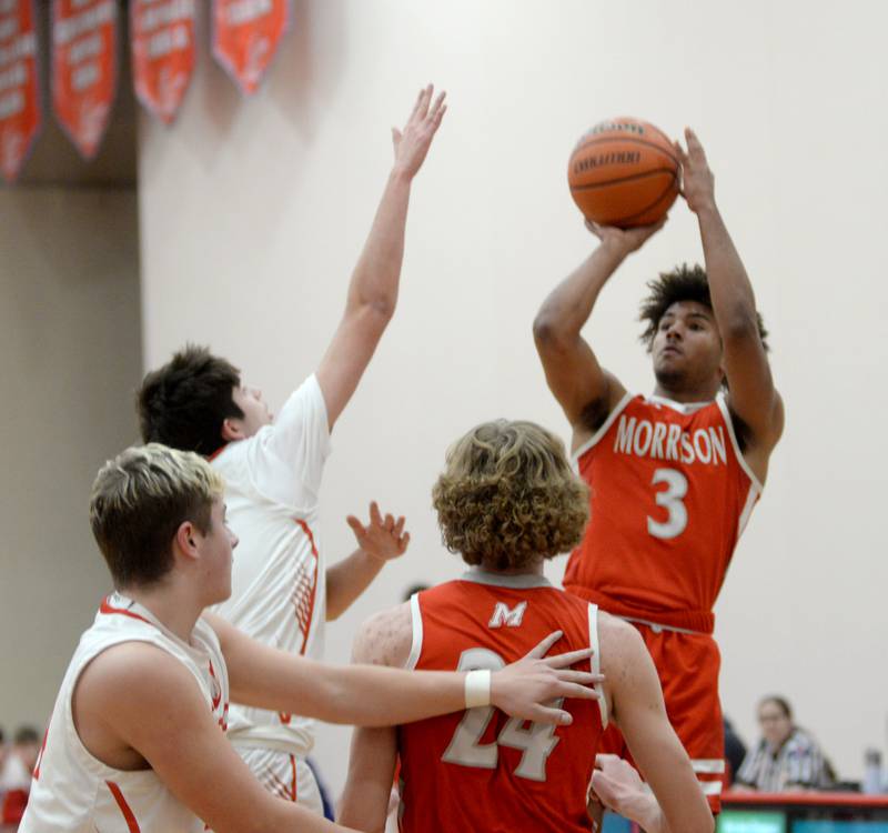 Morrison's DaeShaun McQueen (3) shoots over Oregon defenders during 2A regional action on Monday, Feb. 19, 2024 at the Blackhawk Center in Oregon. The Mustangs downed the Hawks 59-52 to advance to the Prophetstown Regional on Wednesday, Feb. 21.