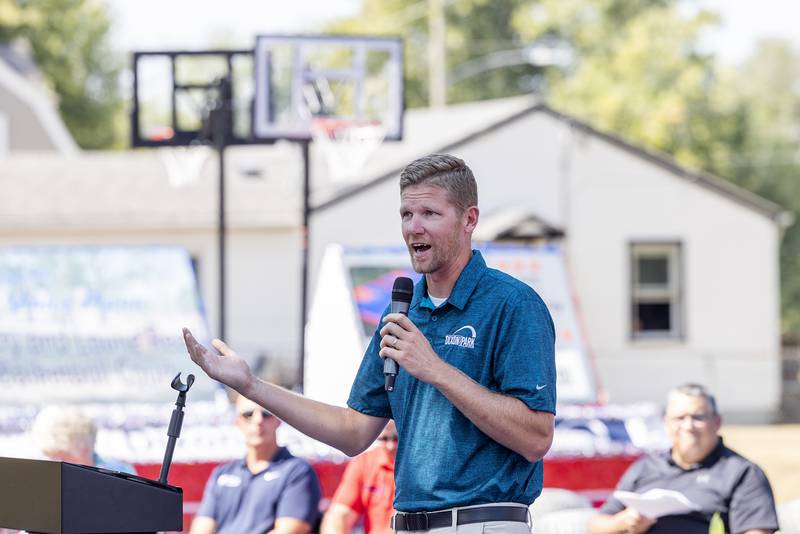 Dixon Park District recreation director Seth Nicklaus talks about the support Larry and Louise Reed have shown the community of Dixon Tuesday, Sept. 17, 2024, during the dedication of basketball courts named after the couple.