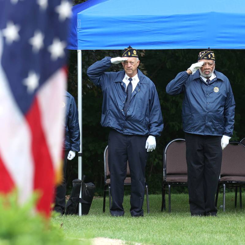 Members of the DeKalb American Legion Honor Guard salute the flag Monday, May 27, 2024, during the singing of “The Star-Spangled Banner” at the DeKalb Memorial Day program at Ellwood House.