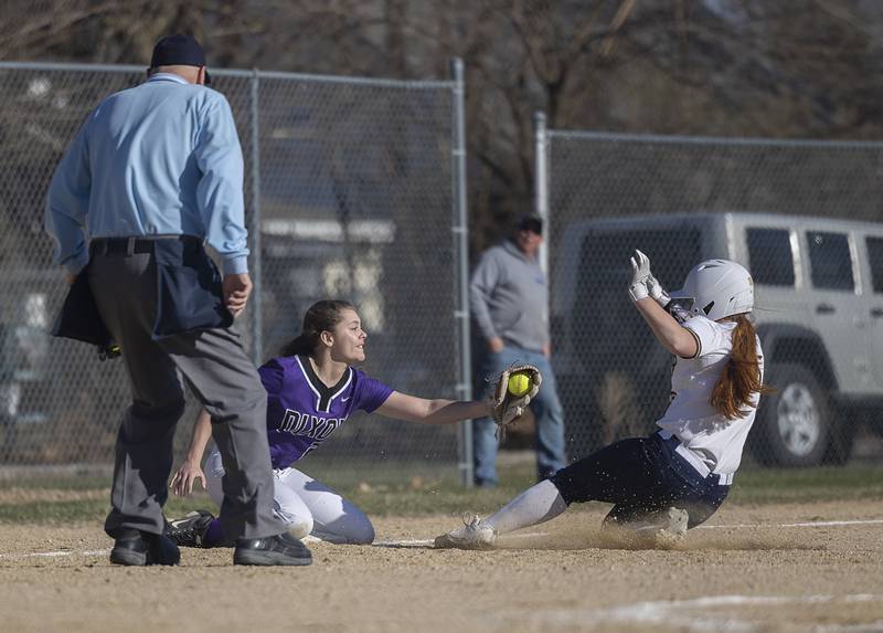 Dixon’s Elly Brown tags out Sterling’s Kennedy Tate at third Tuesday, March 19, 2024 in Dixon.