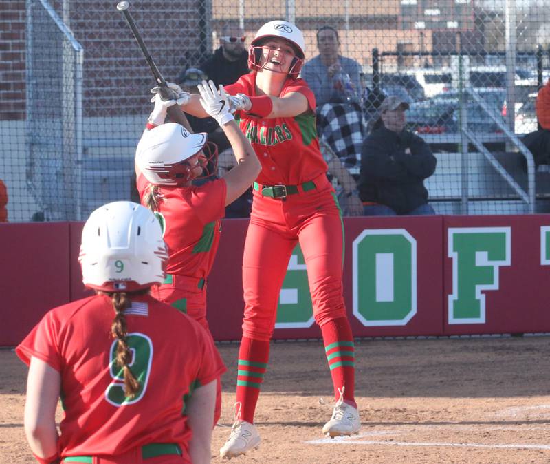 L-P's Karmen Piano hi-fives teammate Kelsey Frederick after scoring the first two runs against Kewanee while teammate Allie Thome watches on Monday, March 11, 2024 at the L-P Athletic Complex in La Salle.