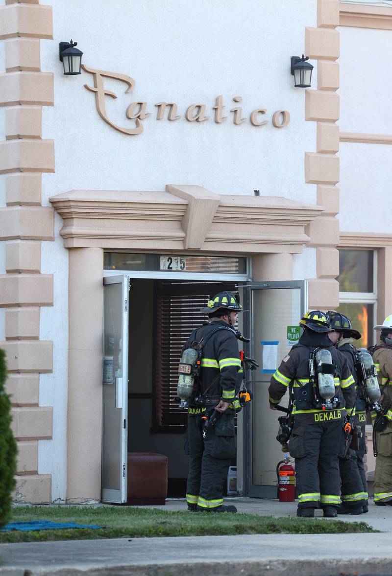 Firefighters exit the site of a structure fire Friday, Sept. 1, 2023, in the building that once housed Fanatico Italian restaurant at 1215 Blackhawk Road in DeKalb.